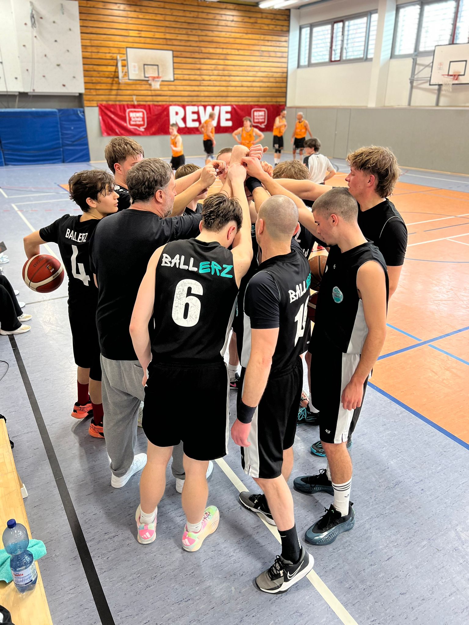 Senior Ballerz stehen im Kreis, die Hände aufeinander zum Schlachtruf